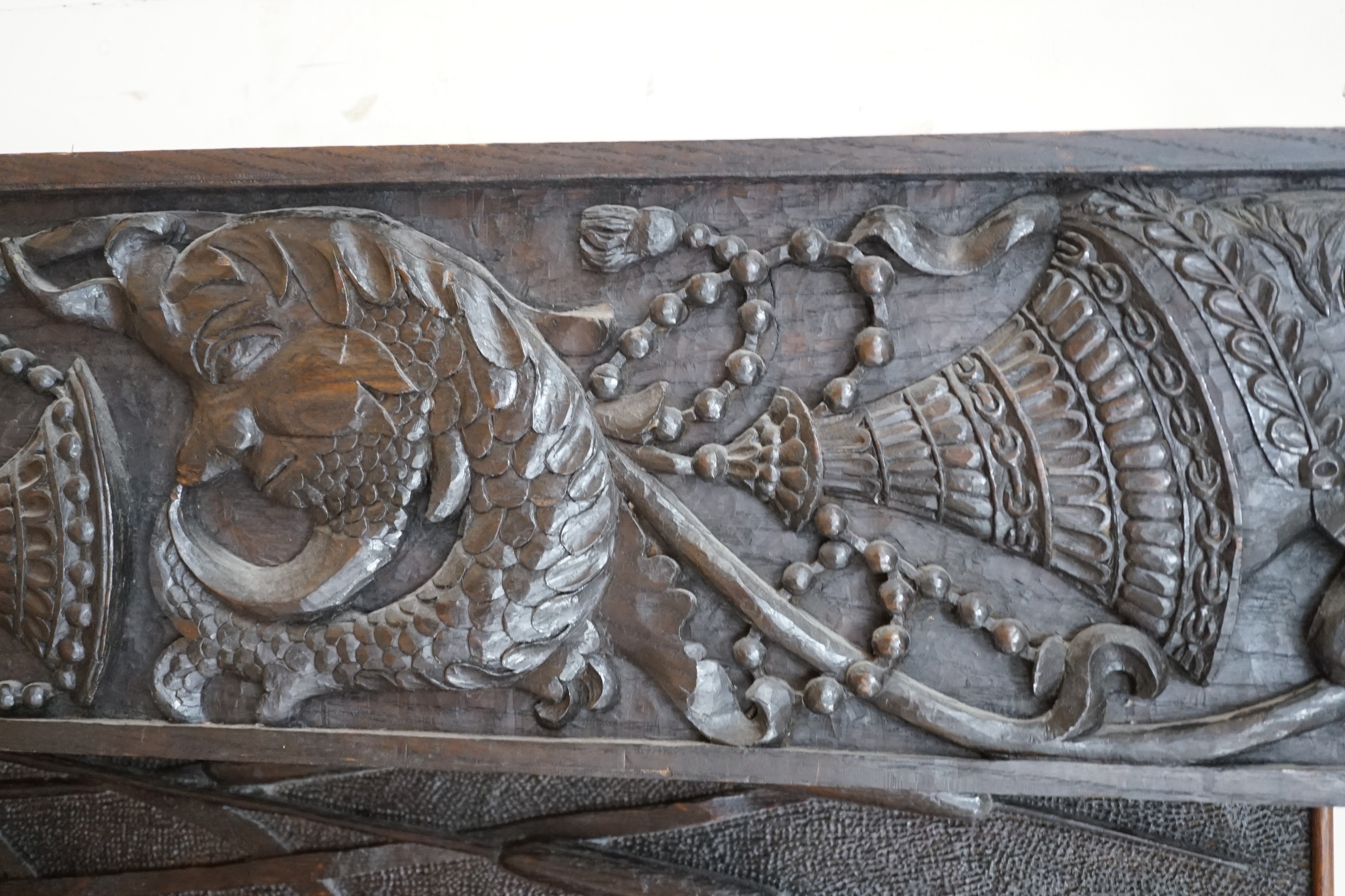 Seven assorted carved wooden panels, widest 166 cms